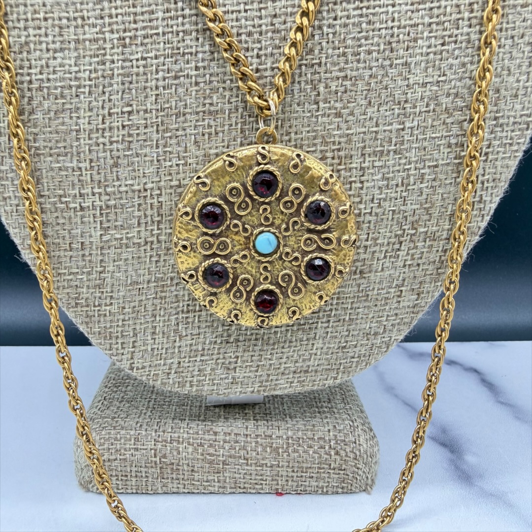Vintage 1960s Goldette faux garnet and turquoise locket necklace up close.